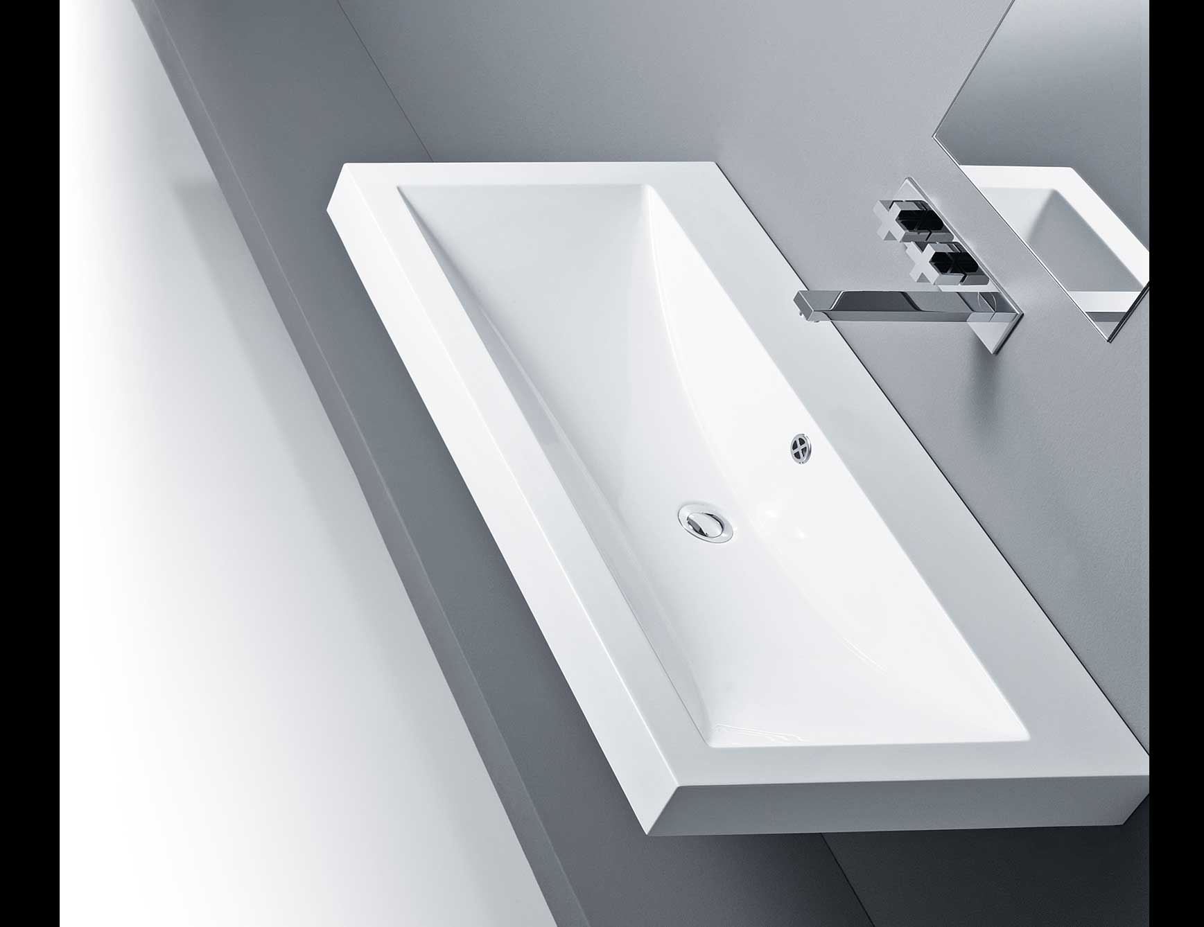 Rectangular white ceramic bathroom sink with chrome faucet